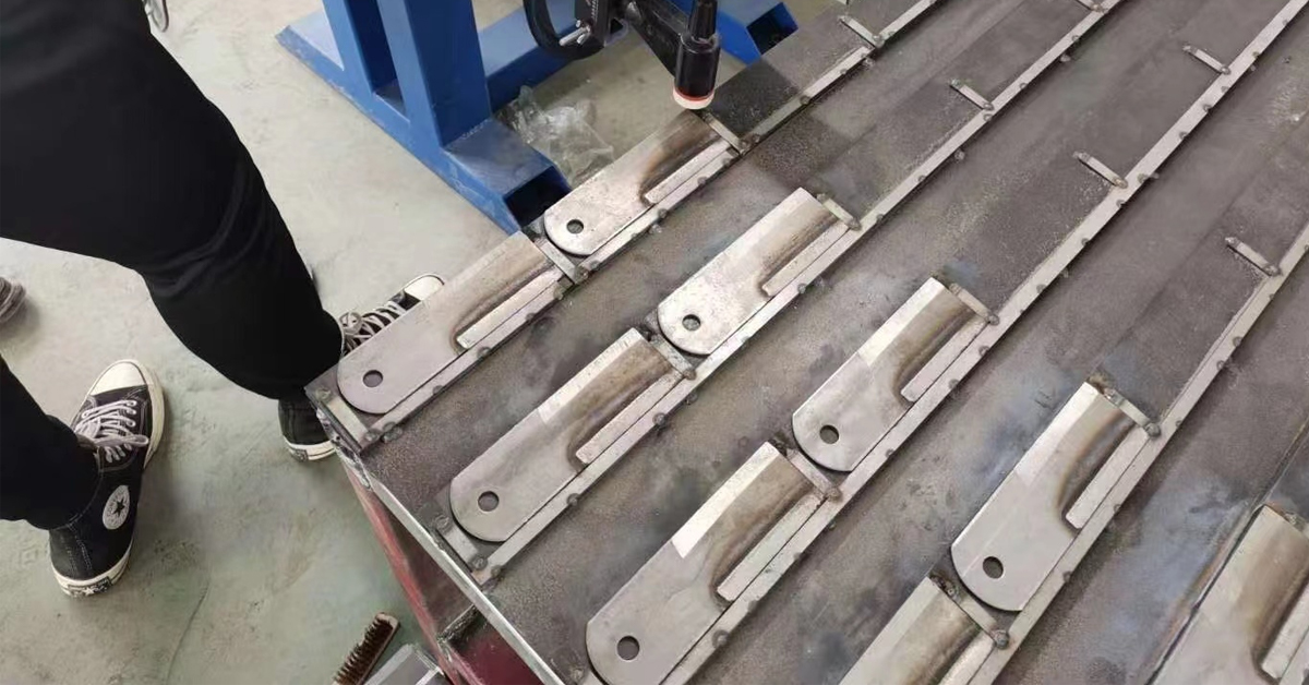 Hammer mill hammer after PTA hardfacing, shown during dimensional and surface inspection.