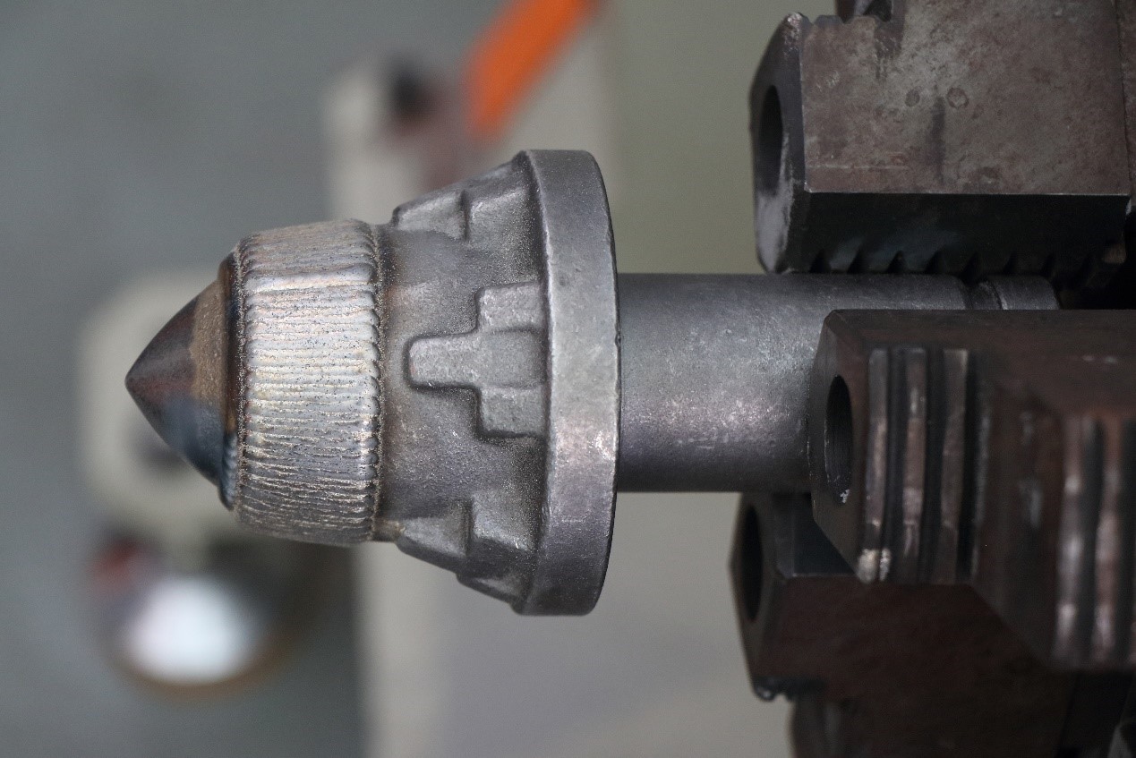 Mining cutting pick after laser cladding showing wear-resistant coating