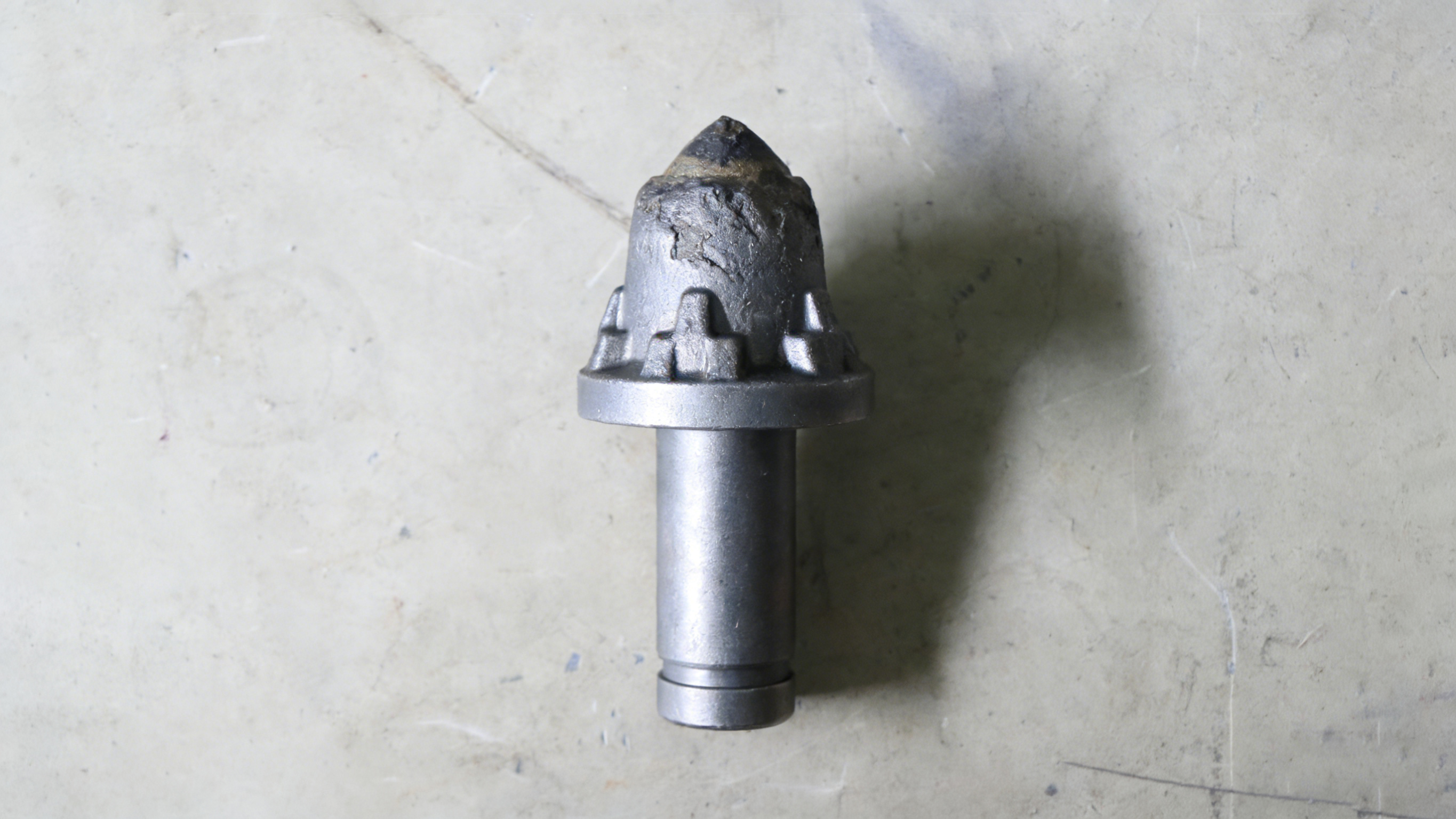 Close-up of worn mining cutting pick surface due to abrasive wear