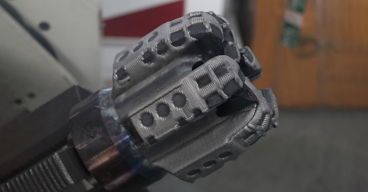 Close-up of a completed laser clad overlay on a PDC drill bit blade